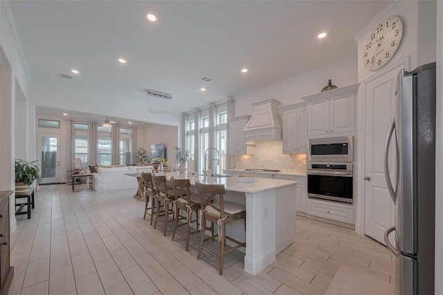 10615 Winding Arbor Ct, Cypress, TX 77433 - kitchen with stainless steel appliances, premium range hood, recessed lighting, a sink, and tasteful backsplash