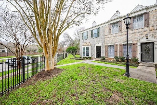 2910 Grants Lake Blvd Unit 1205, Sugar Land, TX 77479 - view of front of house featuring a chimney and brick siding