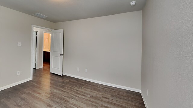 24734 Signorelli Way, Katy, TX 77493 - unfurnished room featuring dark wood-style flooring, baseboards, and a smoke detector
