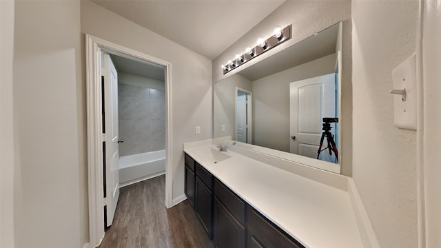 24734 Signorelli Way, Katy, TX 77493 - full bath featuring wood finished floors, vanity, baseboards, and a tub to relax in
