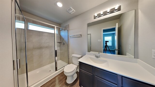 24734 Signorelli Way, Katy, TX 77493 - bathroom with a shower stall, toilet, wood finished floors, and vanity