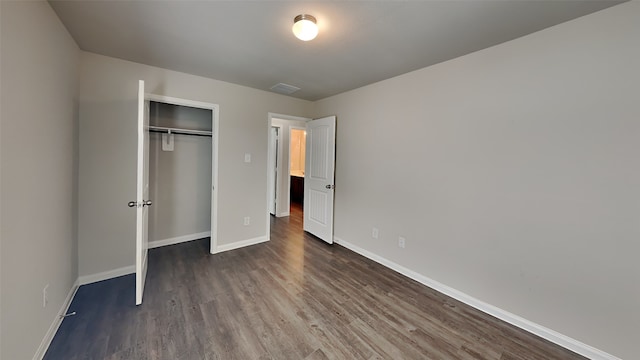 24734 Signorelli Way, Katy, TX 77493 - unfurnished bedroom with dark wood-type flooring, baseboards, and a closet