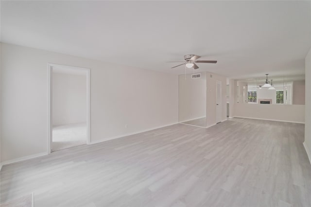 9700 Leawood Blvd Unit 406, Houston, TX 77099 - unfurnished living room featuring light wood-style flooring, ceiling fan, and baseboards
