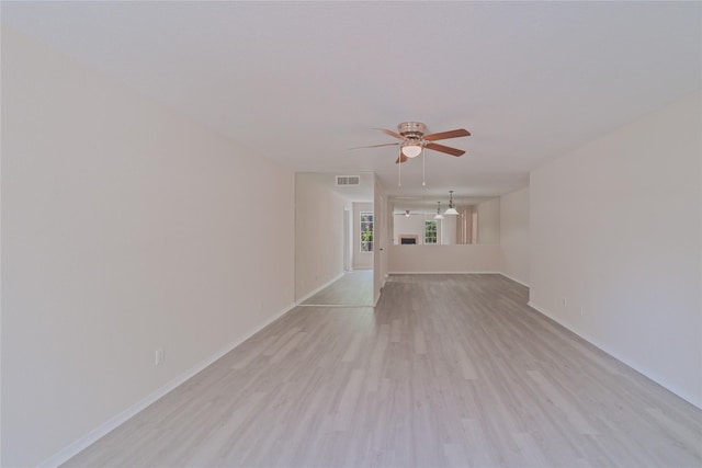 9700 Leawood Blvd Unit 406, Houston, TX 77099 - unfurnished living room featuring ceiling fan, baseboards, and light wood finished floors