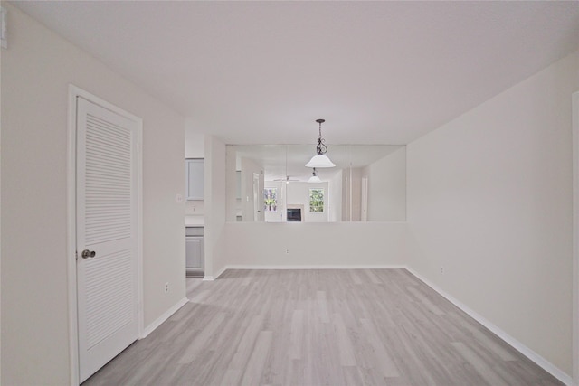 9700 Leawood Blvd Unit 406, Houston, TX 77099 - unfurnished living room with light wood-style floors and baseboards