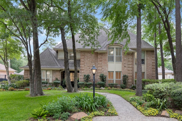 14010 Court Of Regents, Houston, TX 77069 - view of front of property with brick siding, a shingled roof, and a front lawn