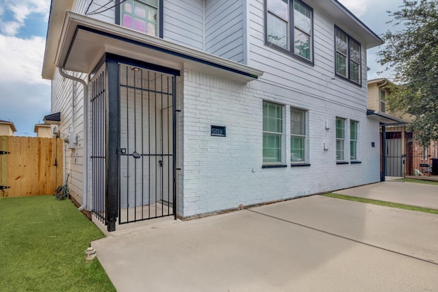 6933 Liverpool St, Houston, TX 77021 - back of house featuring a gate, a patio, and brick siding