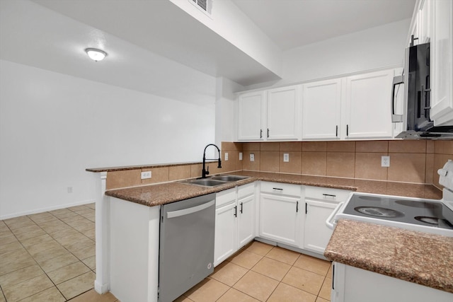 6933 Liverpool St, Houston, TX 77021 - kitchen with appliances with stainless steel finishes, a sink, a peninsula, light tile patterned floors, and backsplash