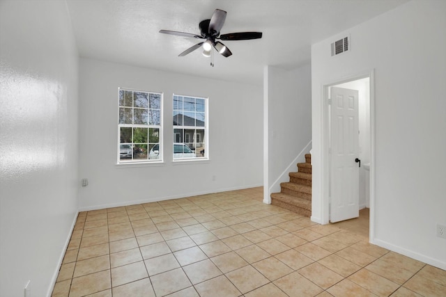 6933 Liverpool St, Houston, TX 77021 - spare room with stairway, light tile patterned floors, ceiling fan, and baseboards