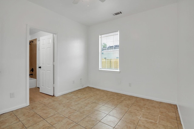 6933 Liverpool St, Houston, TX 77021 - empty room with light tile patterned floors, ceiling fan, and baseboards
