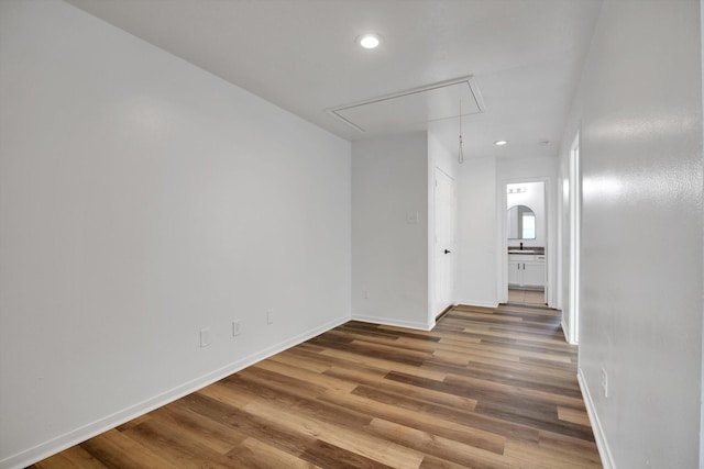 6933 Liverpool St, Houston, TX 77021 - spare room featuring attic access, baseboards, wood finished floors, and recessed lighting