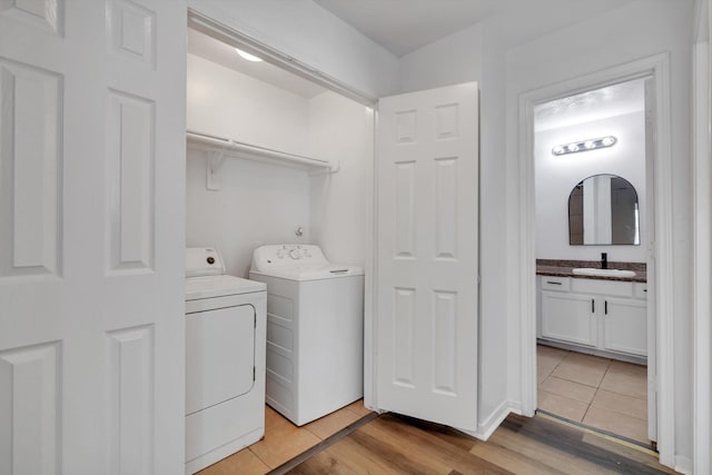 6933 Liverpool St, Houston, TX 77021 - laundry area featuring washing machine and dryer and light tile patterned floors