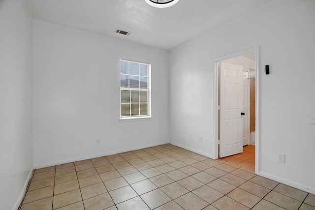 6933 Liverpool St, Houston, TX 77021 - empty room featuring light tile patterned floors and baseboards