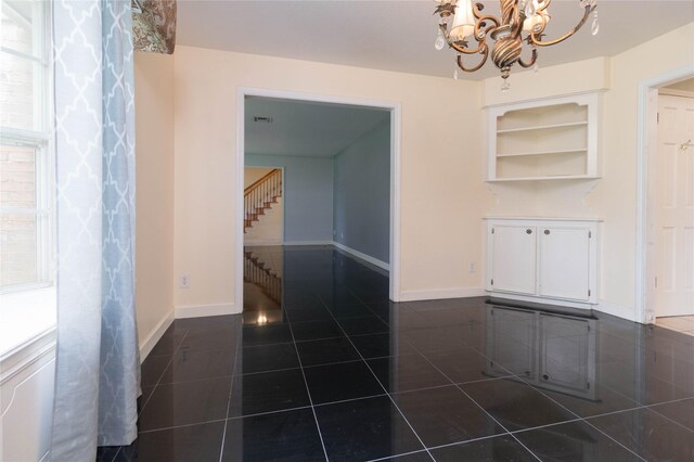 1918 Thousand Pines Dr, Houston, TX 77339 - unfurnished dining area with dark tile patterned floors, a chandelier, baseboards, and stairs