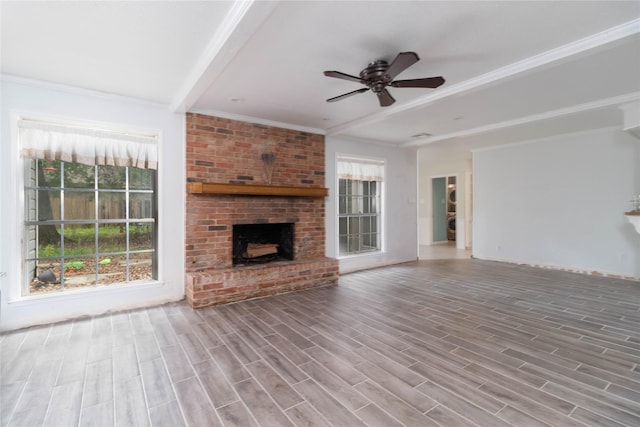 1918 Thousand Pines Dr, Houston, TX 77339 - unfurnished living room featuring a ceiling fan, a brick fireplace, wood finished floors, and crown molding