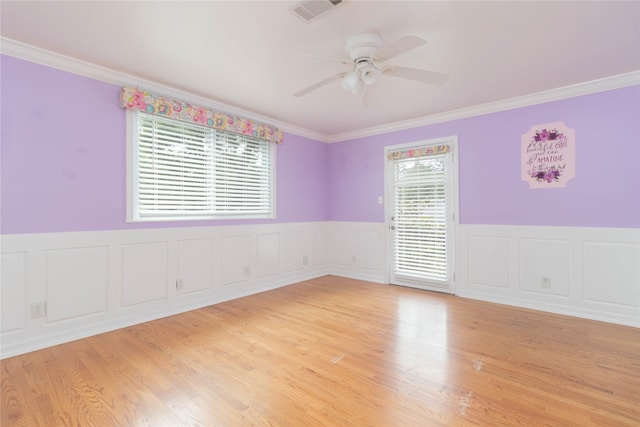 1918 Thousand Pines Dr, Houston, TX 77339 - spare room with a ceiling fan, ornamental molding, wainscoting, light wood-type flooring, and a decorative wall