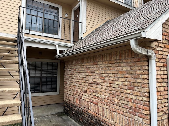 2300 Old Spanish Trl Unit 1111, Houston, TX 77054 - view of side of property featuring brick siding and a shingled roof