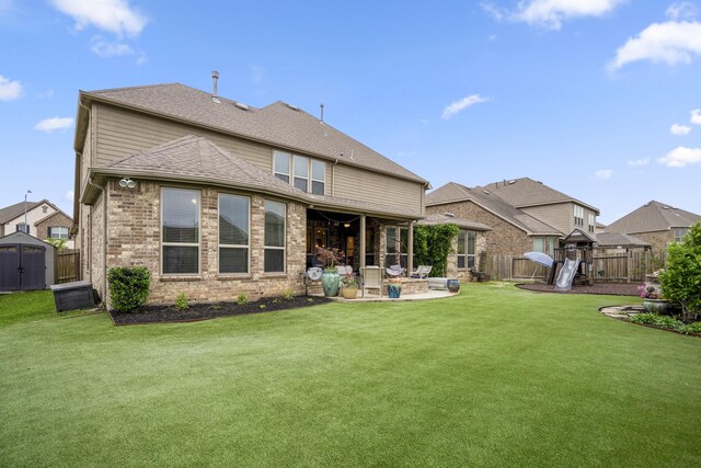 28203 Middlewater View Ln, Katy, TX 77494 - rear view of house with a patio, a playground, and brick siding