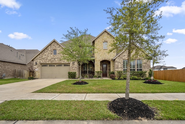 28203 Middlewater View Ln, Katy, TX 77494 - view of front of house featuring stone siding, concrete driveway, and an attached garage