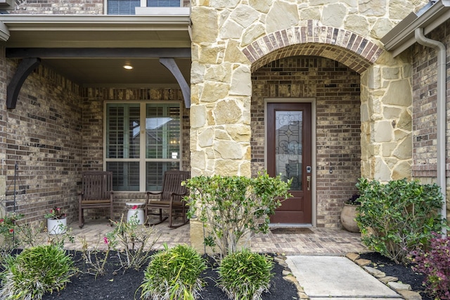28203 Middlewater View Ln, Katy, TX 77494 - property entrance featuring stone siding, covered porch, and brick siding