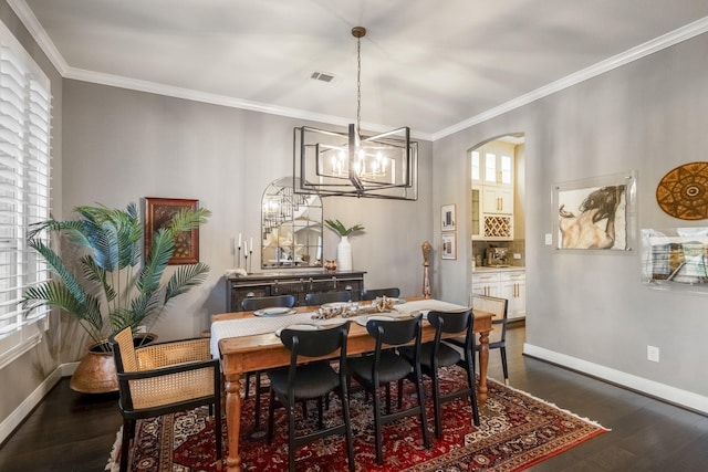 28203 Middlewater View Ln, Katy, TX 77494 - dining area featuring arched walkways, dark wood-style flooring, ornamental molding, baseboards, and a chandelier