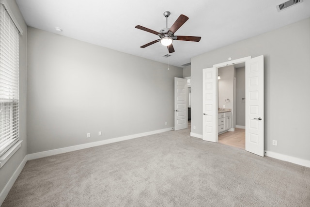 13207 Terania Cliff Trce, Houston, TX 77059 - unfurnished bedroom featuring light colored carpet, baseboards, and connected bathroom