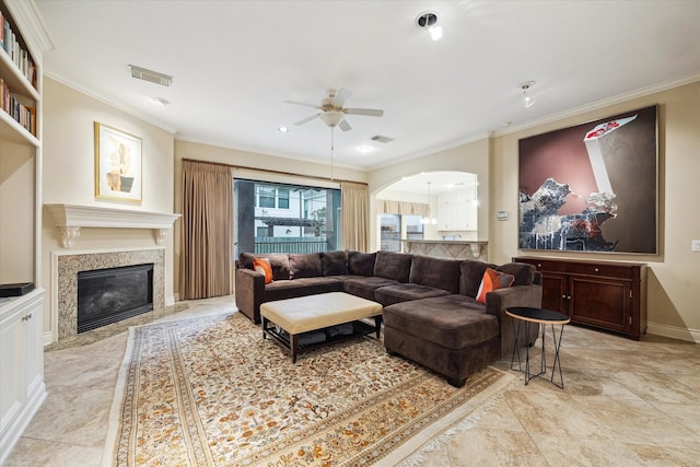 4436 Holt St, Bellaire, TX 77401 - living area with a ceiling fan, crown molding, arched walkways, a fireplace, and baseboards