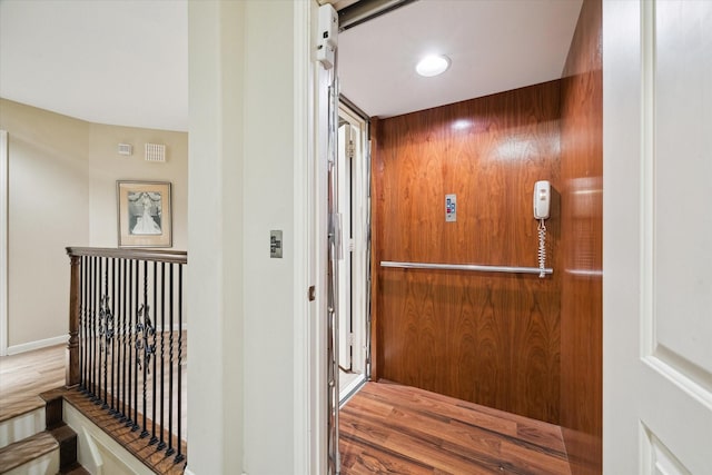 4436 Holt St, Bellaire, TX 77401 - hallway featuring elevator and wood finished floors