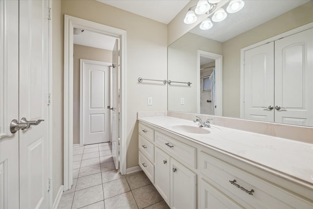 4436 Holt St, Bellaire, TX 77401 - bathroom with tile patterned floors, vanity, and baseboards