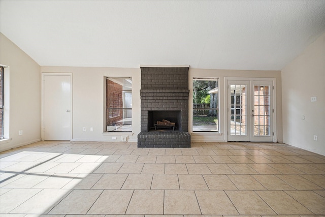 2302 Bright Meadows Dr, Missouri City, TX 77489 - unfurnished living room with vaulted ceiling, light tile patterned floors, and a brick fireplace