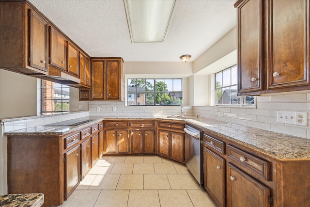 2302 Bright Meadows Dr, Missouri City, TX 77489 - kitchen featuring dishwasher, healthy amount of natural light, black electric stovetop, backsplash, and a textured ceiling