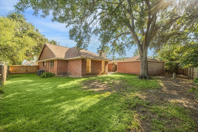 2302 Bright Meadows Dr, Missouri City, TX 77489 - back of house with central AC, a chimney, brick siding, and a shingled roof
