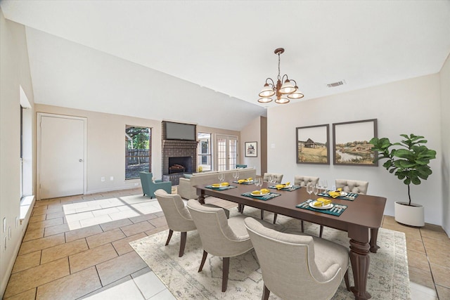 2302 Bright Meadows Dr, Missouri City, TX 77489 - dining space featuring a chandelier, a fireplace, vaulted ceiling, light tile patterned floors, and baseboards