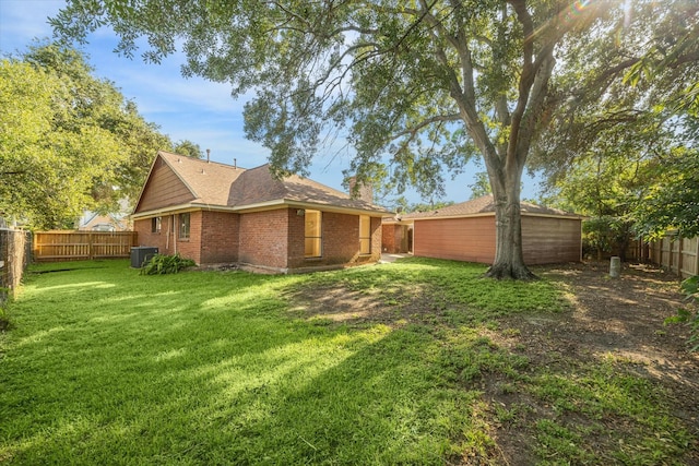 2302 Bright Meadows Dr, Missouri City, TX 77489 - back of house with central AC, a chimney, brick siding, and roof with shingles