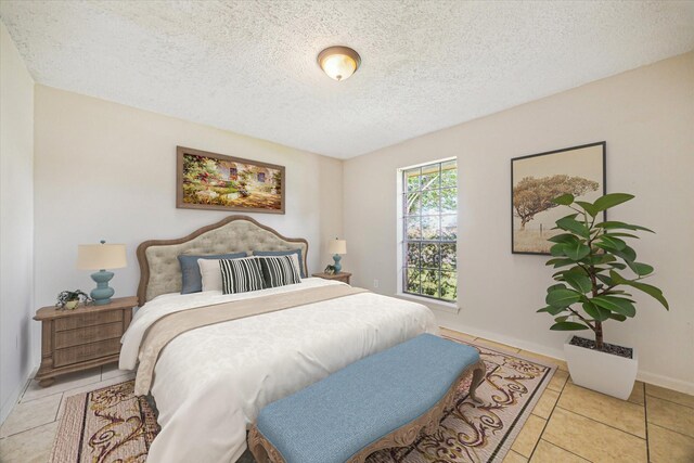 2302 Bright Meadows Dr, Missouri City, TX 77489 - bedroom with a textured ceiling, light tile patterned flooring, and baseboards