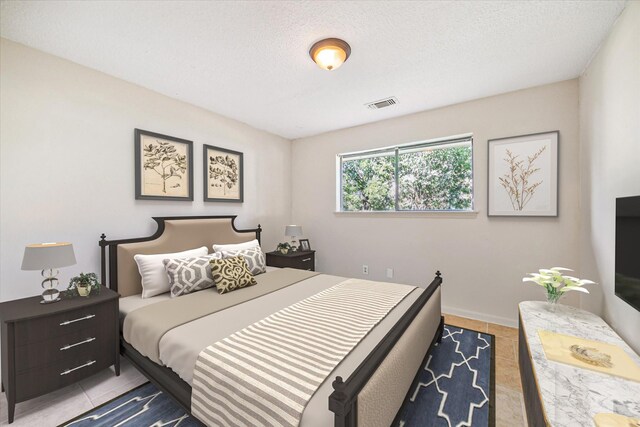 2302 Bright Meadows Dr, Missouri City, TX 77489 - bedroom featuring tile patterned floors and a textured ceiling