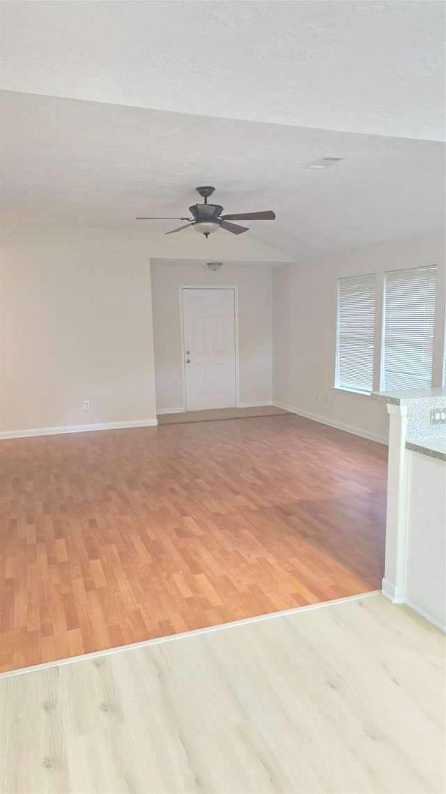 13418 Croquet Ln, Houston, TX 77085 - spare room with light wood finished floors, ceiling fan, and baseboards