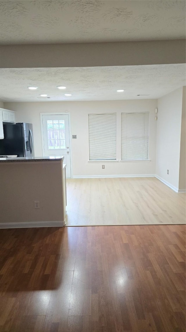 13418 Croquet Ln, Houston, TX 77085 - unfurnished living room featuring light wood-style flooring and baseboards