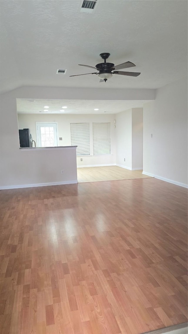 13418 Croquet Ln, Houston, TX 77085 - unfurnished living room with a ceiling fan, light wood-style floors, and baseboards