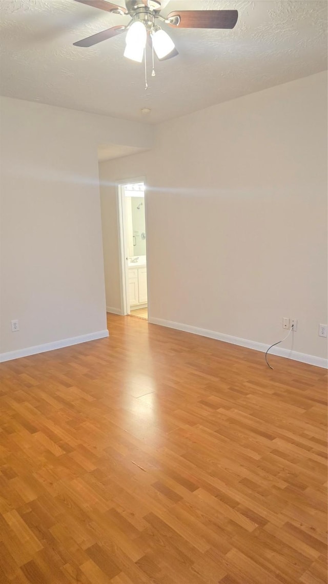 13418 Croquet Ln, Houston, TX 77085 - unfurnished room with a ceiling fan, light wood-style flooring, and baseboards