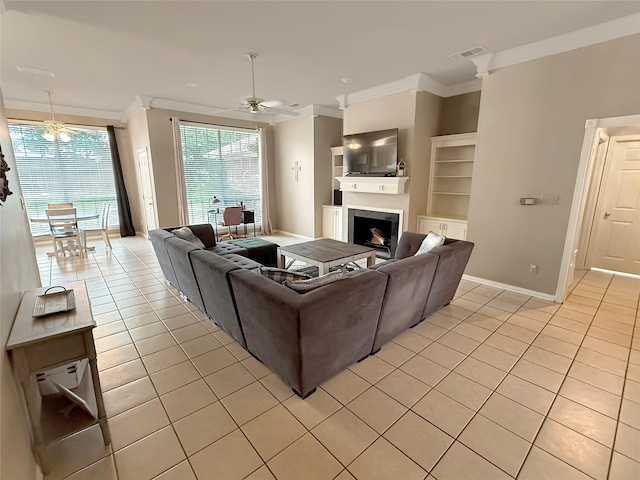 261 Colonial Cir, Athens, TX 75751 - living room featuring a ceiling fan, crown molding, light tile patterned floors, a fireplace, and baseboards