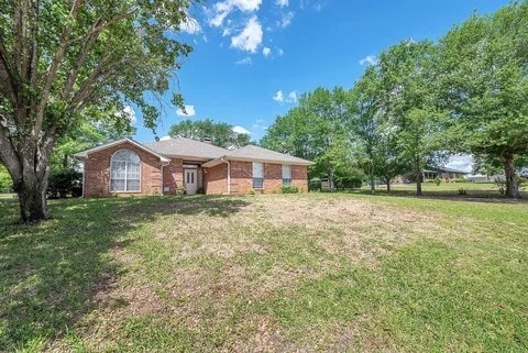 261 Colonial Cir, Athens, TX 75751 - view of front of home with a front yard and brick siding