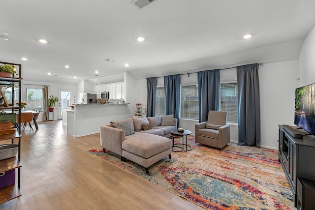 21411 Waldenburg Pl, Tomball, TX 77375 - living area with light wood-style floors, recessed lighting, and baseboards