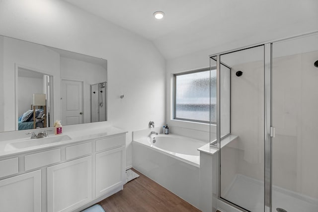 21411 Waldenburg Pl, Tomball, TX 77375 - ensuite bathroom with a shower stall, a bath, wood finished floors, lofted ceiling, and vanity