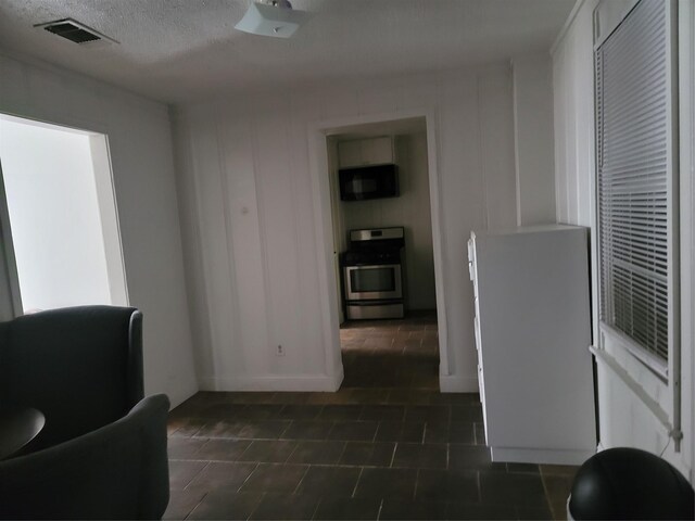 5806 Bayou Bend Ct, Houston, TX 77004 - sitting room with dark tile patterned flooring and a textured ceiling