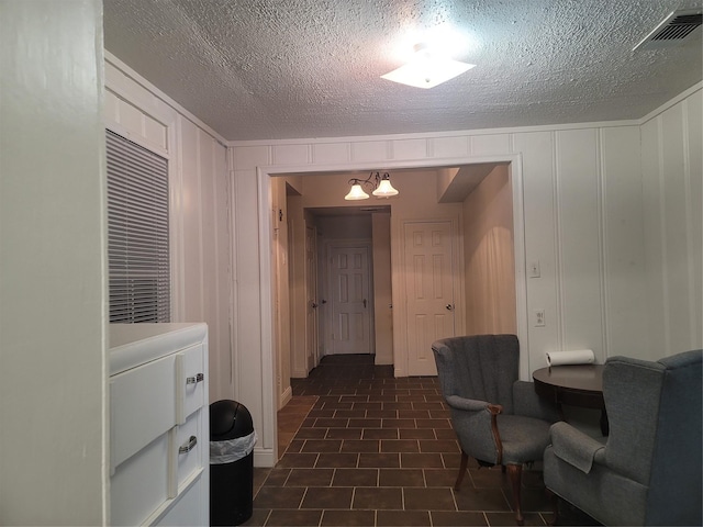 5806 Bayou Bend Ct, Houston, TX 77004 - corridor featuring a decorative wall, a heating unit, dark tile patterned floors, and a textured ceiling