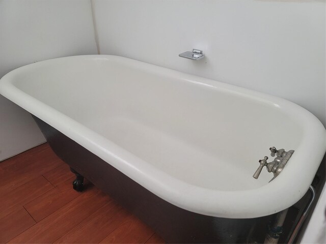 5806 Bayou Bend Ct, Houston, TX 77004 - bathroom with a freestanding bath and wood finished floors