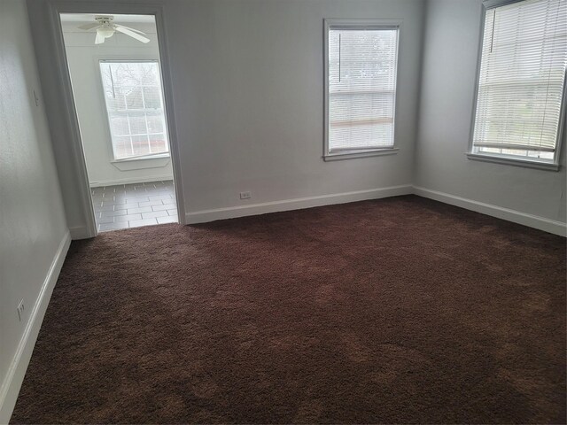 5806 Bayou Bend Ct, Houston, TX 77004 - empty room featuring dark colored carpet, plenty of natural light, a ceiling fan, and baseboards