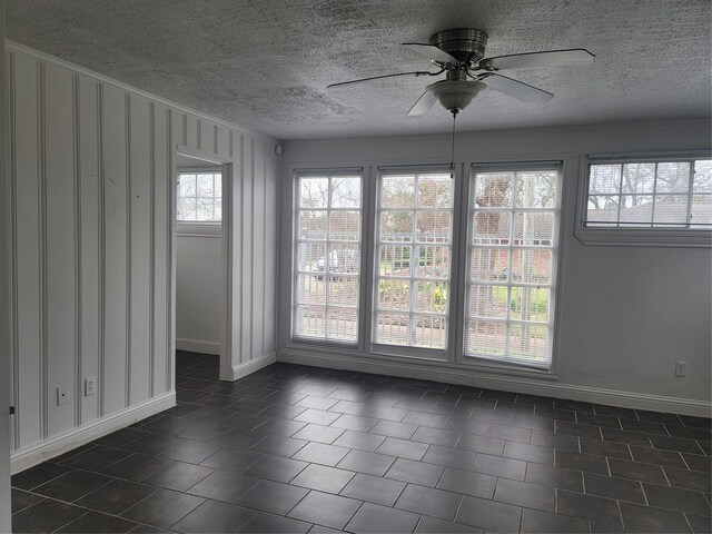 5806 Bayou Bend Ct, Houston, TX 77004 - empty room featuring a textured ceiling, baseboards, and a ceiling fan
