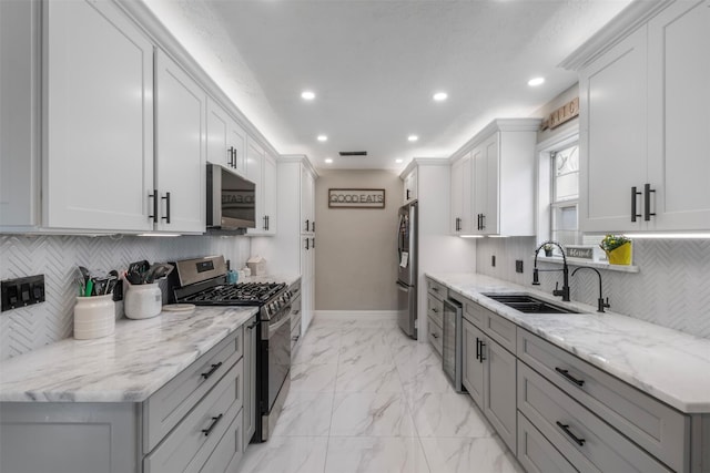 23334 Earlmist Dr, Spring, TX 77373 - kitchen featuring stainless steel appliances, a sink, baseboards, recessed lighting, and decorative backsplash